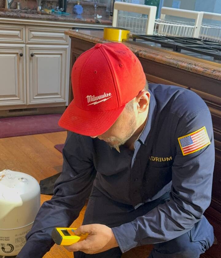 Andrew Kuznetsov, owner and lead technician, charging a rebuilt Sub-Zero 501F sealed system in Blackhawk