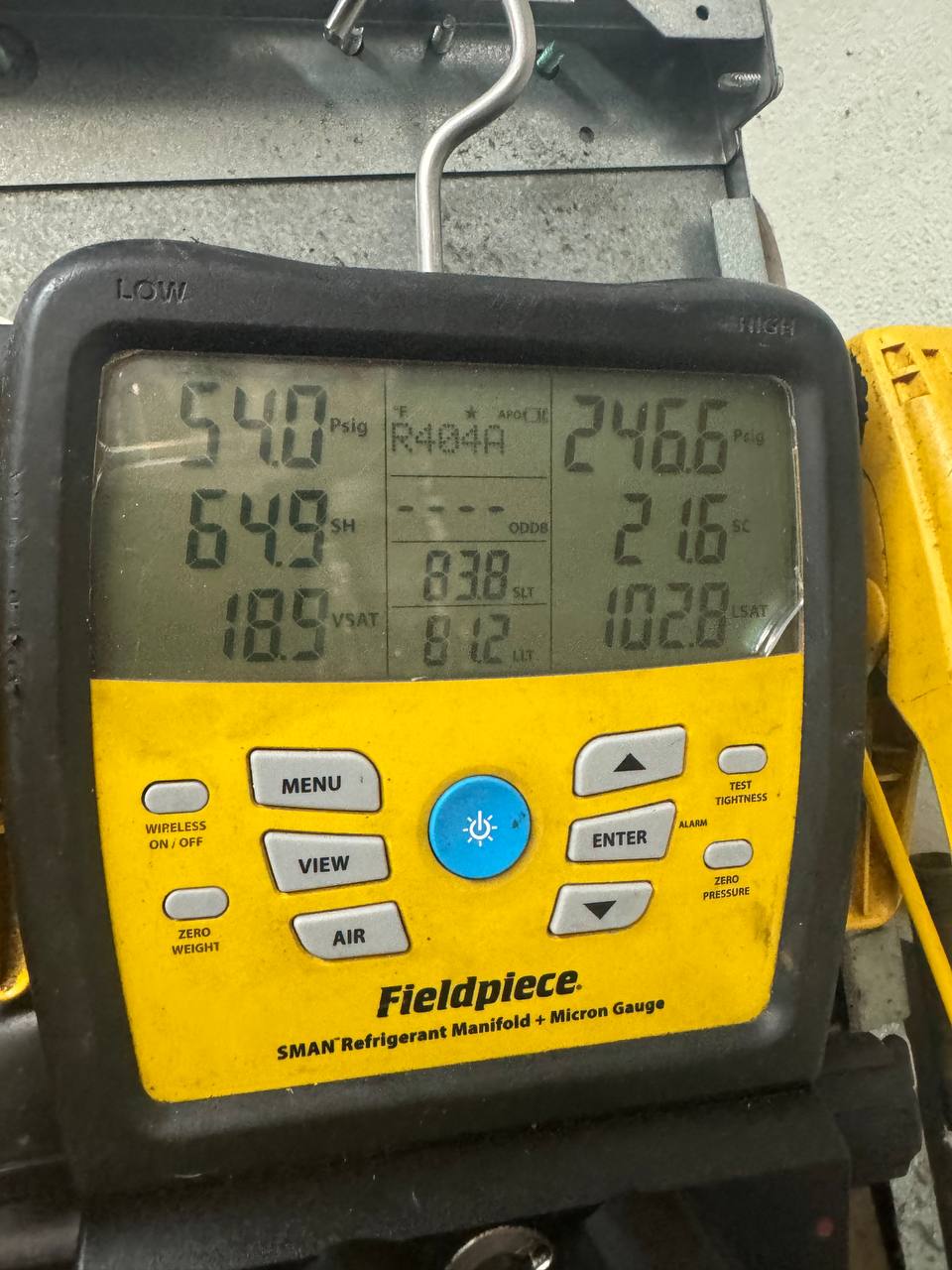 Fieldpiece manifold gauges reading the R404A refrigeration side of the Manitowoc ice machine during diagnosis.