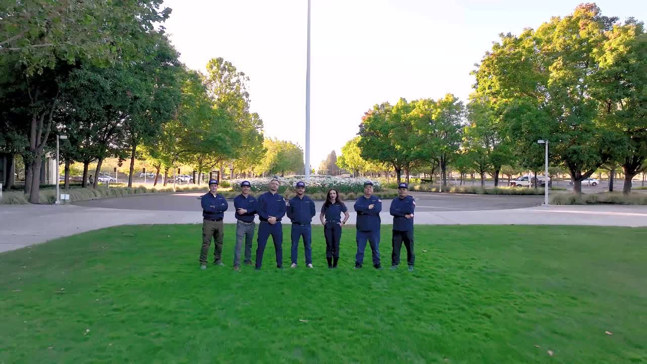 Aerial frame from the team video: the ADRIUM crew on the lawn in San Ramon